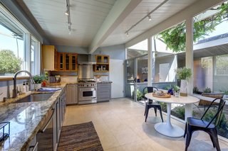 The kitchen features a wall of glass that overlooks the atrium. 