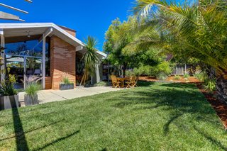 The wraparound backyard is lush and private with a large sun-filled patio.