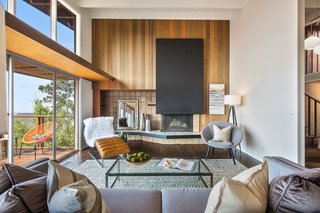 The living room is anchored by a statement fireplace. 