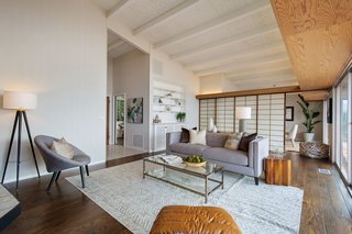 Exposed beams and shoji screens, which conceal the dining area, add to the home's charming character. 