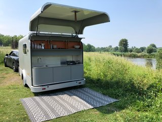 The Lume Traveler’s kitchen is accessed from a rear hatch, similar to a teardrop trailer. There is also a 40-liter fridge below the counter that slides out as needed, and has plenty of storage for all your cooking supplies.