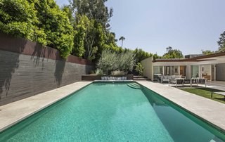 The spa-like pool is the centerpiece of the backyard. 