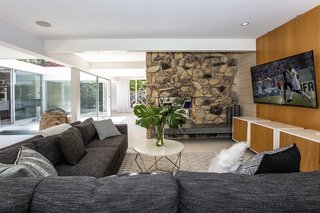 The other side of the fireplace has become a niche to watch TV. 