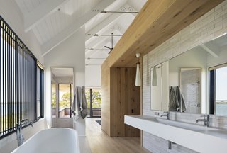 The wood also helps define the bathroom and add a sense of privacy in the space, which has largely been left open. 