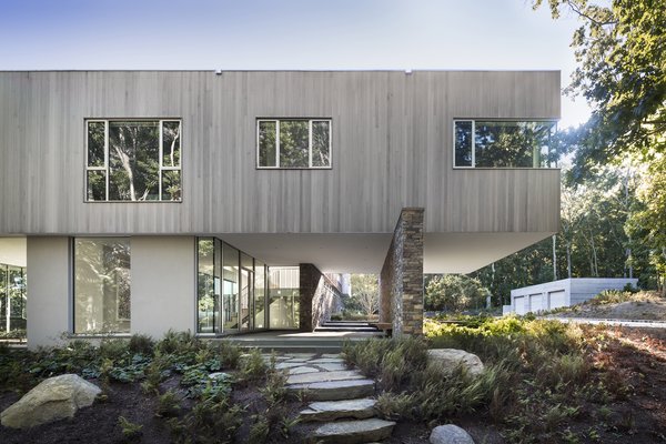 The first floor is made up of glass walls that allow the site to appear to remain uninterrupted.