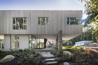 The first floor is made up of glass walls that allow the site to appear to remain uninterrupted. 