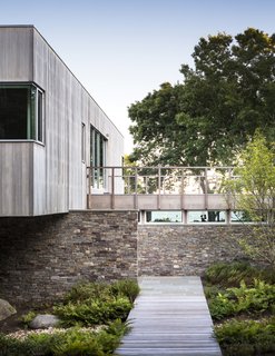 The mix of cedar and stone help integrate the dwelling into its natural setting.