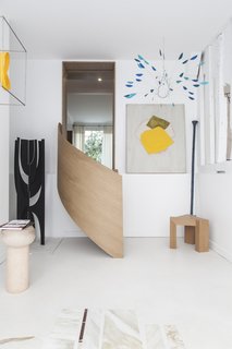 A sculptural staircase elegantly brings visitors down to an additional gallery space. 