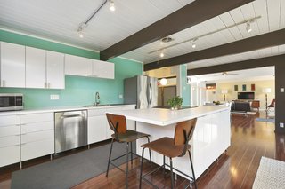 The kitchen has been remodeled and updated with a center island and stainless-steel appliances. 