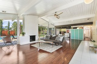 A wood-burning brick fireplace anchors the expansive space. 