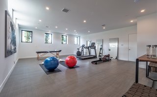 In the basement is a large bonus room with natural light that is perfect for a home gym, playroom, or office. There are two large ensuite guest rooms and a five-car garage with the possibility to expand the parking into the lower basement to accommodate a total of nine cars. 