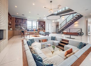 The ground level features an open floor plan with large-format terrazzo flooring. 
