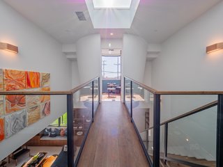 Upstairs, the family level features four ensuite bedrooms plus a steel bridge which leads to a floating "crow’s nest," which could be used as a private office or serene meditation space. 