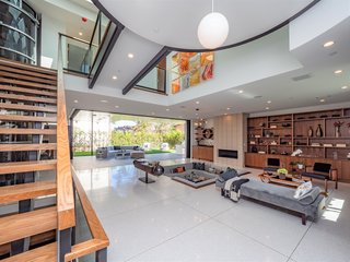 The living room opens to a covered patio, perfect for indoor/outdoor entertaining. 