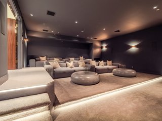 An additional lower level has a large stadium seating with 9.1 surround sound speakers in the walls, and is ready to accommodate a 120-inch screen and projector. 