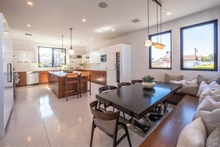 The kitchen also conveniently includes a dining area with built-in seating for casual entertaining or everyday use. 