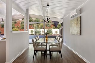 A wall of glass at the back of the home overlooks the landscaped backyard.