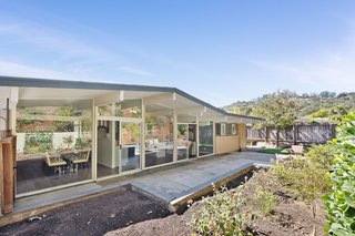 The home is situated on a spacious 9,000-square-foot lot and features a large, private patio, as well as planting beds and several producing fruit trees along the flat lawn area. 