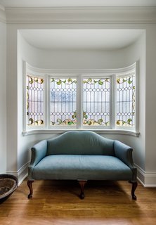 Newly commissioned stained glass adorns the music room and staircase, while thick, curved banisters, crown moldings, and 10-inch beveled baseboards are modern touches of what would have been native to the home. The existing Jatoba floor underwent chemical treatment to help bring out more period-appropriate hues. 