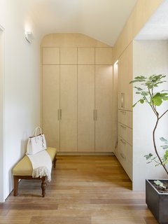 A large dressing room in the master suite shows off a uniquely customized built-in closet, which is perfectly inserted into the original curve of the ceiling. 