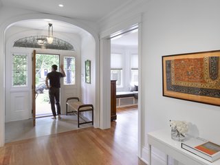 The grand stained-glass entry opens onto a central hall that stretches throughout the original part of the home that contains the living area and music room. 