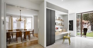 Contemporary details in the kitchen flow into the dining room where a preserved sense of the home's original Edwardian character continues to exist. 
