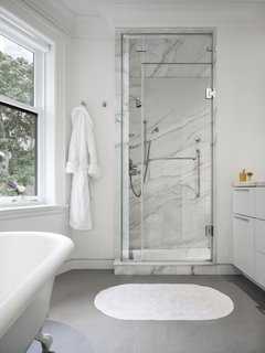 The master bedroom also has a marble-clad ensuite bathroom. 