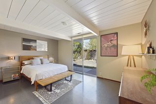 The large master bedroom features a walk-in closet and has direct access to the backyard. 