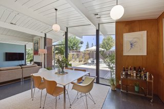Globe pendant lighting brightens the home while bringing an authentic midcentury touch to the dining room. 