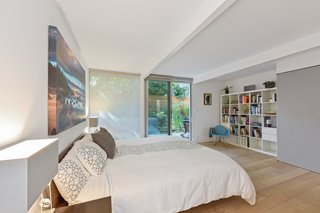 The large master bedroom features sliding doors to the outdoor space. 