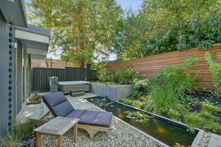 There is even a private meditation garden off the master with a zen pond, waterfall feature, and a hot tub.