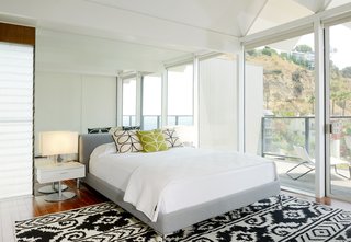 The bright and spacious master bedroom features sliding doors that lead to the terrace. 