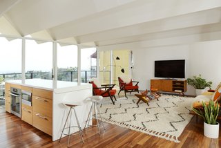 The living space has spectacular views thanks to the floor-to-ceiling wall of glass. 