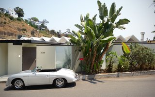 The front of the home features a privacy wall and a peek at the pleated roofline. 