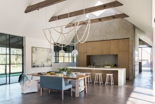 Light filters into the home via skylights and extensive glazing, opening the interiors up into the courtyard and extending the home's visual range out into the vineyard beyond. 