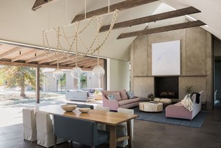 Field Architecture has framed the sloped ceiling differently in each room of the house—from the skylight that disappears into the gable’s peak and floods the hearth with light, to the slice the ceiling takes through the hallway.