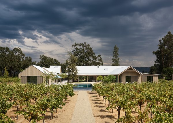 Nestled between sprawling trees, the property sits on the valley floor, leaving a courtyard space with a pool in the center.