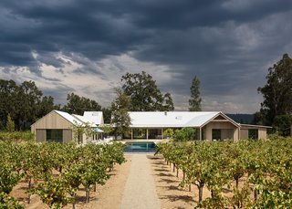 Nestled between sprawling trees, the property sits on the valley floor, leaving a courtyard space with a pool in the center. 