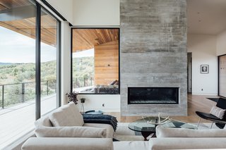 The simple indoor/outdoor material palette consists of horizontal, natural cedar anchored by board-formed concrete. "The cedar siding was an easy pick, adding some warmth to the gray concrete, but also making the house blend with nature. We chose a non-knotty cedar for a more modern appearance," says Axboe. 