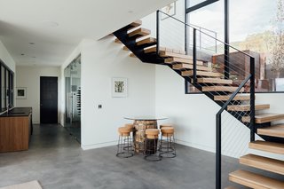 Stairs lead to a lower level family room, complete with a wine cellar. 