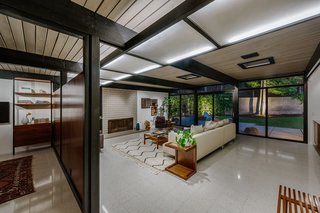 A dividing wall separates the living room from the adjacent den. 