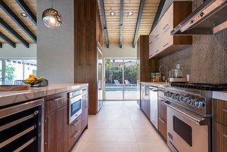 The kitchen also boasts spectacular views of the mountains and easy access to the pool, spa, fire pit, and outdoor kitchen. 