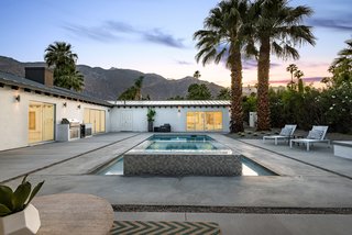 The resort-like outdoor space features breathtaking views of the surrounding mountain range. 