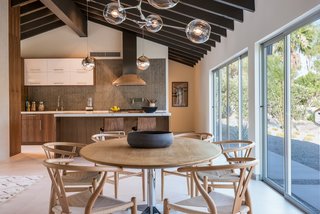 The updated kitchen features a Viking Pro gas range, custom cabinetry, new imported Italian flooring, and a convenient kitchen island with bar seating. 