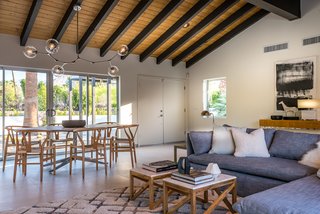 The great room features an open floor plan, as well as a vaulted tongue-and-groove ceiling. 