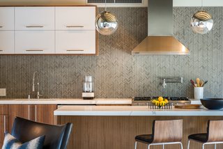 A herringbone tile pattern forms the backsplash. 