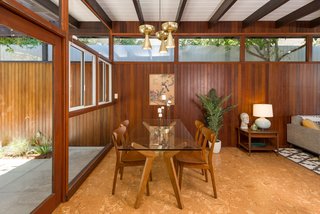 A look at the dining area. Note how the wood paneling appears to extend straight out into the fence on the exterior. 