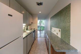 The kitchen connects the front and the back of the home. 