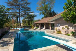 The covered patio area enhances the indoor/outdoor living experience. The swimming pool features a solar heating system that’s perfect for entertaining throughout the year. 