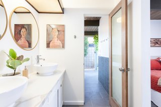 The master bathroom has been expanded and features an indoor-outdoor shower space. 